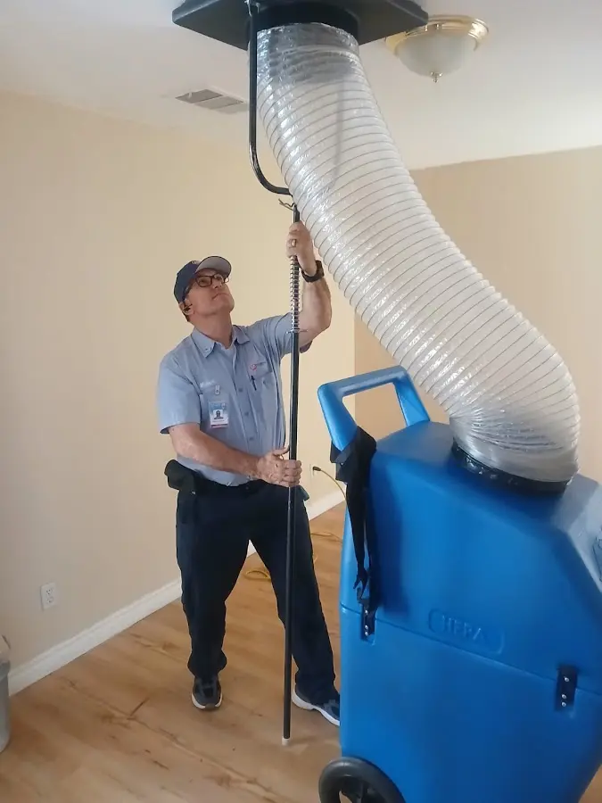 Furnace Tune-Up technician using HEPA equipment in Wright
